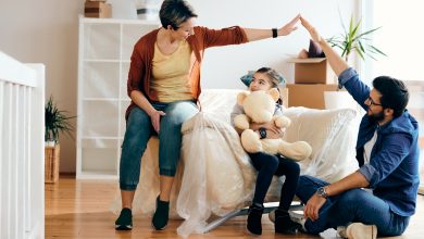 happy-family-having-fun-while-moving-into-their-new-home